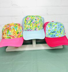 These adorable hand-painted whimsical trucker hats are the perfect pop of color for your summer look and the best gift for your friends and family. The size of the bill is 2 3/4". No two are alike. These hats are mesh back and have a snapback Spring Beach Trucker Hat, 5-panel, Cute Multicolor Hats For Vacation, Fun Multicolor Trucker Hat For Beach, Cute Summer Hats With Curved Bill, Fun Summer Trucker Hat With Curved Bill, Playful Mini Cap Hats For Spring, Playful Spring Beach Baseball Cap, Playful Spring Mini Cap Hat, Playful Spring Baseball Cap