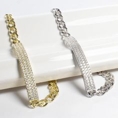 Always on the look-out for the latest fashion trend? This gorgeous rectangle bar bracelet twinkles with cubic zirconia stones. The nice link chain has a lobster clasp and makes this the perfect accessory for any occasion. This bracelet will be the perfect gift for that special someone in your life. - Stones Material: Cubic Zirconia.- Stones Shape: Round.- Metal: 925 Sterling Silver.- Plating: Gold and Rhodium plated.- Length: 7" (17.8 cm) and 1.8 cm adjustable.- Size of Charm: 5 mm wide x 4 cm l Rectangular Jubilee Bracelet In Cubic Zirconia, Trendy Silver Cubic Zirconia Chain Bracelet, Rectangular Cubic Zirconia Bracelets, Trendy Cubic Zirconia Chain Bracelet For Party, Silver Cubic Zirconia Bracelet With Rectangular Links, Silver Rectangular Cubic Zirconia Bracelets, Party Bracelets With Rectangular Links, Silver Cubic Zirconia Diamond Bracelet Rectangular Shape, Rectangular Silver Diamond Bracelet With Cubic Zirconia