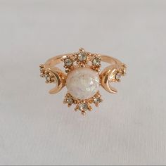 Gold Plated, White Opal (Simulated) Celestial Ring. Features The “Sun”, “Moon”, And “Stars” Represented By The Different Stones. Item Is A Size 6, New, And Unworn. Please Ask Me Any Questions You May Have Prior To Making A Purchase. Engagement Rings Sun, Opal And Pearl Engagement Ring, Sun And Moon Wedding Rings, Gold Sun Ring, Adjustable White Jewelry With Sun And Moon Design, Adjustable White Sun And Moon Jewelry, Adjustable White Celestial Rings, Sun And Moon Themed Wedding, Star Engagement Ring