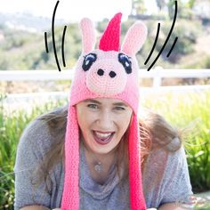 a woman wearing a pink knitted hat with ears