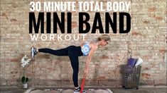 a woman doing a yoga pose with the words 30 minute total body mini band workout