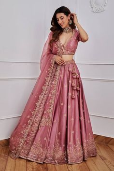 Aurora pink lehenga with gold dori, aari and sequin embroidery. Comes with half sleeves blouse and organza dupatta. Component: 3 Pattern: Embroidery Type Of Work: Sequin, Dori and Aari Neckline: Leaf Sleeve Type: Half Fabric: Chanderi and Organza; Lining: Satin Color: Pink Other Details:  Dupatta with scalloped embroidery border Tassels on the sides Note: Only selling the product mentioned in the description from the video. Occasion: Wedding - Aza Fashions Lehenga For Party Indian Weddings, Lehenga Look For Reception, Pink Lehenga Reception Look, Night Wedding Lehenga, Engagement Lengha Indian, Lengha Poses In Wedding, Lehnga Bridal Designs Indian Weddings, Wedding Dresses Lengha, Two Piece Wedding Dress Indian