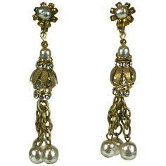 two pairs of earrings with pearls on them