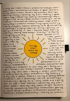 an open book with writing on it and a sun drawn on the page in yellow