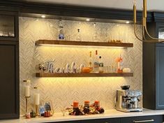 the kitchen is decorated in black and white with gold accents, such as shelving above the counter