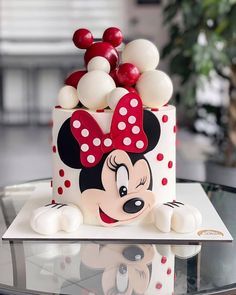 a mickey mouse cake with red and white decorations