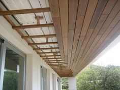 an outdoor patio with wood slats on the ceiling