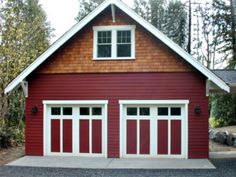 a red garage with two doors and windows