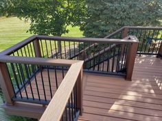 a wooden deck with metal railing and hand rail