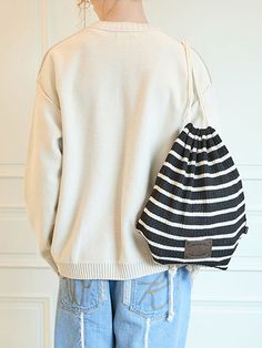 It is a drawstring bag made of textured knit fabric. The drawstring length is adjustable to fit different body shapes.- Logo label- Logo patch- Stripe pattern- Unisex item Casual Knitted Pouch Bag, Casual Knitted Shoulder Bag, Casual Cotton Pouch Bag, Casual Black Knitted Shoulder Bag, Casual Bucket Bag, Casual Drawstring Shoulder Bag For Travel, Casual Travel Shoulder Bag With Drawstring, Casual Pouch Drawstring Bag, Casual Pouch Drawstring Bag For Daily Use