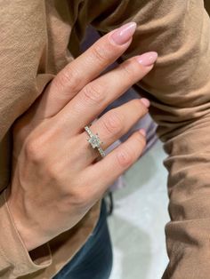 a woman's hand with a diamond ring on it