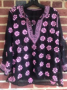 "Pit to pit 22\"Extra room measures 22 Side Straight down measure 20\"/sleeve length about 19\"/Length 24 1/2\" /Smoke free environment/Side slits 6 1/2\"/embroidered tunic top/clean no /Button down front/appears to be hand embroidered/ good vintage condition/Last 3 pictures show the backside proving it is hand embroidered.You can see the spread from one flower to the other. This shirt has a lot of work into it (9)" Traditional V-neck Top With Chikankari Embroidery, Casual Long Sleeve Tops With Resham Embroidery, Casual Resham Embroidery Blouse For Spring, Casual Resham Embroidered Blouse For Spring, Casual Long Sleeve Blouse With Resham Embroidery, Casual Blouse With Resham Embroidery, Traditional V-neck Chikankari Embroidered Top, Spring V-neck Block Print Blouse, Bohemian V-neck Top With Chikankari Embroidery