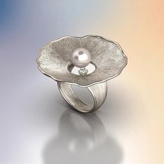 Discover the allure of our Pearl and Diamond Ring, a masterpiece of Italian craftsmanship. This exquisite ring features an 8mm Akoya White Pearl set in your choice of 14k or 18k solid gold—available in yellow, white, or rose gold. Complemented by a 0.1 Ct natural diamond, this ring is a perfect blend of sophistication and timeless beauty. Handcrafted in Vicenza, Italy, this ring embodies the finest traditions of Italian jewelry making. Its organic design, inspired by nature, adds a unique touch