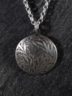 "The classic and timeless William Morris - inspired Willow pattern, acid-etched into a silver disc, 25mm or 1 inch diameter.  The disc is fabricated from 1mm sterling silver sheet and slightly domed to create a limited-edition pendant. Following the chemical etch, the image is slightly oxidised to add contrast to the image, before the entire piece is brushed to leave a matte-silver finish. If you would prefer a polished finish on this piece, please message me. To echo the disc shape, two rings c Etched White Gold Round Pendant Necklace, White Gold Etched Round Pendant Necklace, Sterling Silver Etched Round Disc Necklace, Etched Sterling Silver Round Necklace, Nature-inspired Engraved Oval Pendant Necklaces, Nature-inspired Engraved Oval Pendant Necklace, Nature-inspired Etched Round Pendant Jewelry, Sterling Silver Round Pendant Necklace With Engraving Option, Nature-inspired Engraved Round Pendant Necklace