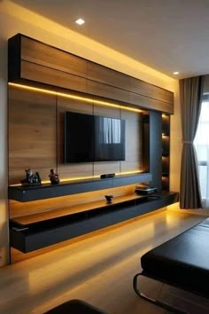 modern living room with black furniture and large tv mounted on the wall in front of window