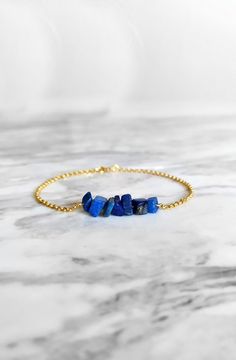 Maat. Inspired by the ancient egyptian goddess Maat. This bracelet is composed of 14K gold vermeil delicate chain and raw lapis lazuli gemstones in royal blue shades. So delicately pretty for everyday! It also makes a very cute gift! Available in: ❉ 14K Yellow Gold vermeil ❉ 14K Rose Gold vermeil ❉ 925 Sterling Silver You can choose between 6 chain lengths: 5.5 / 6 / 6.5 / 7 / 7.5 / 8 inches Not sure which length to buy? We can add a 1 inch extender chain. Just write a note at checkout! ❈ We sen Sapphire Lapis Lazuli Bracelets As Gift, Gold Lapis Lazuli Bracelet With Gemstone, Minimalist Adjustable Lapis Lazuli Jewelry, Adjustable Minimalist Lapis Lazuli Jewelry, Gold Lapis Lazuli Gemstone Bracelet, Blue Spiritual Bracelets With Birthstone, Spiritual Blue Birthstone Bracelets, Gold Bracelets With Lapis Lazuli And Natural Stones, Lapis Lazuli Gemstone Beads Bracelets As Gift