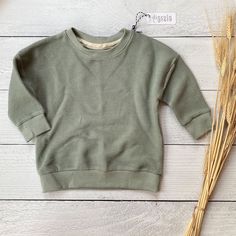 AVERY PULLOVER CREWNECK in Organic Soft Moss Green Waffle Knit. 2-3 WEEK TURNAROUND TIME This soft green waffle knit pullover is the perfect addition to any little's winter wardrobe! Though great for all year cuteness! Perfect fall, winter, spring, and even summer. On it's own, or layered over top for extra warmth, it's great. Sweater is long sleeved, with a dolman style sleeve- meaning the top of the shoulder drops down a little bit. It has matching cuffs and waistband. The body fabric is a 95% Green Waffle Knit Crew Neck Top, Cute Long Sleeve Soft Knit Tops, Cozy Green Top For Everyday, Crew Neck Waffle Knit Sweatshirt For Layering, Cute Winter Tops For Everyday Wear, Crew Neck Waffle Knit Sweater In [color], Waffle Knit Long Sleeve Sweatshirt For Loungewear, Crew Neck Waffle Knit Sweater, Cotton Waffle Knit Long Sleeve Sweatshirt