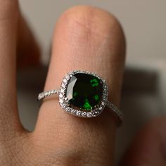 This halo ring features a 8*8mm cushion cut natural diopside and sterling silver finished with rhodium. Customization is available. It is made by hand, and it will take about 7 days to finish the ring after your payment is completed. Main stone: chrome diopside Diopside weight: Approx 2.40 ct Metal type: sterling silver finished with rhodium Accent stone: cz Customization is available, I also can make it with 14k solid gold (white or yellow or rose) and diamond accent stone, just feel free to co Chrome Diopside Ring, Gemstone Engagement Ring, Green Gemstone Ring, Ring Cushion, Cushion Cut Ring, Cushion Ring, Top Rings, Gemstone Engagement, Cushion Diamond