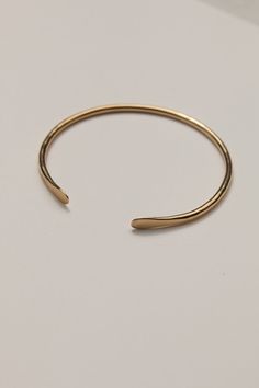 14k recycled gold-plated brass 14k gold-plated sterling silver ear posts Approximately 6" around wrist Nickel & lead free Crafted using responsibly sourced and recycled metals Handmade in a solar-powered workshop in rural Malawi The 'Mawoko' Bracelet (meaning 'Arm' in Tumbuka) is an essential addition to any jewelry collection. The bracelet features an adjustable, practical design to ensure the perfect fit for most wrists, while its hammered finish and smoothed teardrop ends create an elevated, Adjustable Everyday Jewelry In Recycled Gold, Yellow Gold Brass Cuff Bracelet, Adjustable Gold Bracelet In Recycled Gold, Adjustable Gold Bracelet In Recycled Material, Adjustable Gold Bracelets In Recycled Material, Everyday Brass Bracelets, Tarnish Resistant, Minimalist Brass Bracelets, Minimalist Brass Bracelets Tarnish Resistant, Minimalist Tarnish Resistant Recycled Gold Bracelet