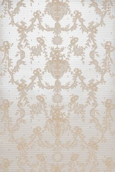 an ornate wallpaper pattern in beige and white