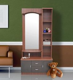 a teddy bear is sitting in front of a mirror and shelf with a medicine cabinet