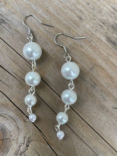 These earrings are made with white glass Pearl beads White Pearl Linear Earrings, White Beaded Pearl Earrings, Handmade White Dangle Clip-on Earrings, White Pearl Beaded Drop Earrings, Nickel-free White Dangle Jewelry, White Sterling Silver Earrings With Dangling Beads, White Pearl Drop Beaded Earrings, Beaded Pearl White Drop Earrings, Pearl Beaded Drop Earrings