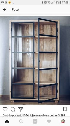 a wooden bookcase with glass doors on top