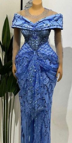 a mannequin wearing a blue evening gown