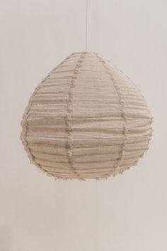 a white paper lantern hanging from a string