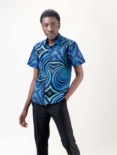 Our Mankon short Sleeve shirt is made of 100% cotton and features a relaxed, fitted silhouette. The African print on this lightweight shirt is subtle but bold, and the colors are beautiful. It's the perfect shirt for any occasion! Description 100% Cotton African Print Wax Short sleeves Front button Top length is 20 inches Made in Cameroon Fabric from Benin Care instructions hand wash cold iron on wrong side hang to dry do not bleach Blue Cotton Short Sleeve Shirt For Summer, Fitted Blue Short Sleeve Shirt For Summer, Blue Fitted Short Sleeve Shirt For Summer, Printed Collared Cotton Short Sleeve Shirt, Relaxed Fit Hawaiian Shirt With Graphic Print, Printed Relaxed Fit Hawaiian Shirt, Printed Relaxed Fit Hawaiian Shirt Short Sleeve, Printed Cotton Short Sleeve Shirt, Fitted Cotton Shirt With Graphic Print