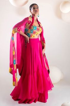 Fuchsia pink batwing sleeves cape with persian patchwork adorned with sequin highlights. Paired with a patchwork and hand embroidered blouse and a ruffled skirt. - Aza Fashions Pink Dupatta Set With Cape Sleeves, Pink Cape Sleeves Set With Dupatta, Pink Sets With Dupatta And Cape Sleeves, Pink Silk Sequined Set, Pink Silk Set With Sequins, Pink Sequined Silk Set, Pink Designer Dress With Cape Sleeves, Pink Cape Sleeves Dress With Sheer Dupatta, Designer Pink Dress With Cape Sleeves