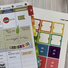 two planner pages with stickers on them sitting next to each other in front of a wooden table