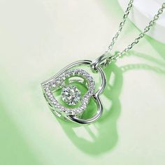 An eye-catching round moissanite dances with ease at the center of this appealing women's necklace, expressing your unstoppable love. Additional round gem set in sterling silver frame the center. Features Moissanite was originally found in meteorites(Chemical name: Silicon Carbide). It was first discovered in 1893, while a scientist was examining meteor samples from a crater in Arizona. After many years, the experts has been recreated moissanite in the laboratory, that make the gemstone with fri Valentine's Day Moissanite Jewelry With Center Stone, Silver Jewelry With Heart Cut Halo Design, Silver Heart Cut Jewelry With Halo Design, Round Halo Design Jewelry For Valentine's Day, Silver Moissanite Heart Pendant Necklace, Anniversary Cubic Zirconia Heart Necklace With Round Cut, Anniversary Heart Necklace In Cubic Zirconia With Round Cut, Silver Heart Cut Solitaire Necklace For Anniversary, Silver Round Necklace With Center Stone