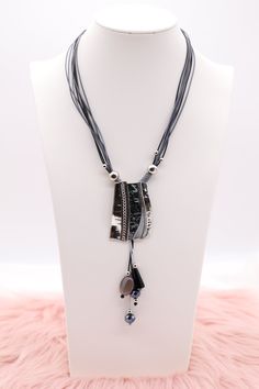 The "Silver and Black Metal Pendant with Dangling Stones, Multi Black and Silver Rope Necklace" showcases a sophisticated pendant combining silver and black metal, adorned with elegantly dangling stones that add movement and sparkle. This pendant hangs from a necklace made of intertwined black and silver ropes, creating a dynamic and textured look that is both modern and striking. Length: 18” (18 extensions) Pendant: 2.03” (Length) 1.40” (Width) Closure: Lobster Claw Clasp Material: Brass with S Adjustable Gray Metal Necklace, Black Metal Necklaces With Silver Beads, Black Metal Necklace With Silver Beads, Black Necklace With Silver Beads, Black Metal Dangle Necklaces, Black Metal Dangle Necklace, Black Necklace With Silver Chain, Black Beaded Metal Dangle Necklaces, Silver Necklace With Black Beads For Party