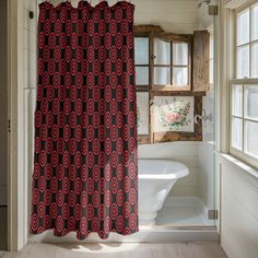 a red and black shower curtain in a bathroom