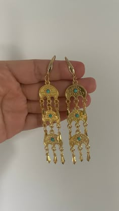 traditional sar parcham charm earrings approx 4 inches long  the sar parcham charm is a moon shaped charm with a blue stone. typically worn in jewelry in many Kurdish areas. Blue Metal Earrings With Latkans, Blue Dangle Chandelier Earrings With Latkans, Blue Chandelier Dangle Earrings With Latkans, Blue Latkans Chandelier Dangle Earrings, Traditional Dangle Chandelier Earrings, Bohemian Half Moon Metal Earrings, Elegant Blue Earrings With Moon Charm, Elegant Crescent Earrings For Festival, Elegant Crescent Shaped Festival Earrings