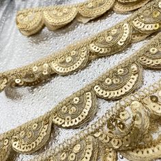 gold sequins and beads on white fabric