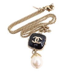 Authentic Chanel black enamel and pearl in yellow gold necklace. Featuring a Chanel logo pendant with dangle pearl. This necklace is absolutely gorgeous. The chain has a lobster clasp with a Chanel tag. Marked 08A Made in France Chain measures 17" Chanel Pearl, Leather Formal Shoes, Chanel Pearls, Yellow Gold Necklace, Chanel Logo, Enamel Necklaces, Formal Shoes For Men, Bag Packaging, Chanel Black