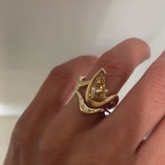 a woman's hand with a yellow diamond ring on it