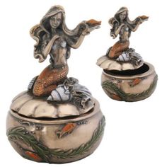 an image of a statue that is on top of a pot with fish in it