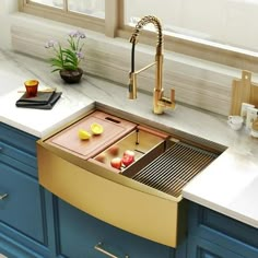 a kitchen with blue cabinets and white countertops has a gold dishwasher in the center