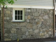 a stone wall with a window in it