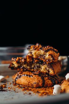 three cookies stacked on top of each other with white marshmallows around them