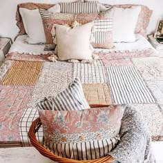 a bed that has some pillows on it and a basket in front of the bed