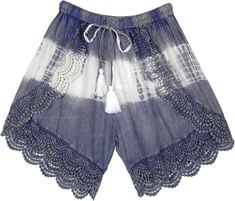 A stonewashed steel blue rayon shorts with white tie-dye in the mid - these cross shorts feature a beautiful crochet lace on the edges to enhance the bohemian look and cute drawstring tassels in white.  These pair of shorts have a streaky sophistication about them with the texture and fall. #tlb #Stonewash #Yoga #vacationclothing #beachwrap #TieDye #bohemianfashion #BohemianShorts #TieDyeShorts #BeachShorts Blue Bohemian Shorts For The Beach, Blue Bohemian Shorts For Beach, Bohemian Blue Shorts For The Beach, Bohemian Blue Shorts For Beach, Summer Festival Bottoms With Crochet Trim, Bohemian Bottoms With Crochet Trim For Summer, Bohemian Summer Bottoms With Crochet Trim, Bohemian Style Shorts With Crochet Trim For Summer, Bohemian Shorts With Crochet Trim For Vacation