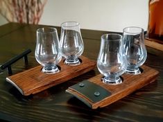 three glasses are sitting on a wooden tray