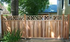 a wooden fence in front of a house