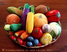 a basket filled with lots of different types of fruits and vegetables on top of a wooden table