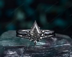 a diamond ring sitting on top of a rock