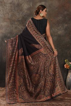 Exquisite black Kani weave tussar muga saree is one of a kind drape for a saree wardrobe! It comes with a matching blouse piece. Shop designer sarees in USA from Pure Elegance. The shown stitched blouse on the model is for display purpose only. The saree comes with a matching blouse piece and finished with fall and piko. Disclaimer: The actual product may vary slightly from the image. These are custom orders, hence expect slight variation in color, placement of the motif or buta. ESTIMATED DELIVERYBecause this is a custom order, it would take about 4 weeks from the date of purchase. RETURN POLICYThis product is a custom order and cannot be returned or exchanged. Black Pashmina Dupatta In Traditional Drape, Black Festive Pashmina Shawl In Traditional Drape, Traditional Black Pashmina Shawl, Festive Black Pashmina Shawl With Dupatta Detail, Festive Black Pashmina Dupatta, Black Anarkali Traditional Wear With Motifs, Black Anarkali With Motifs, Designer Black Jamawar Traditional Wear, Black Anarkali Jamawar Traditional Wear